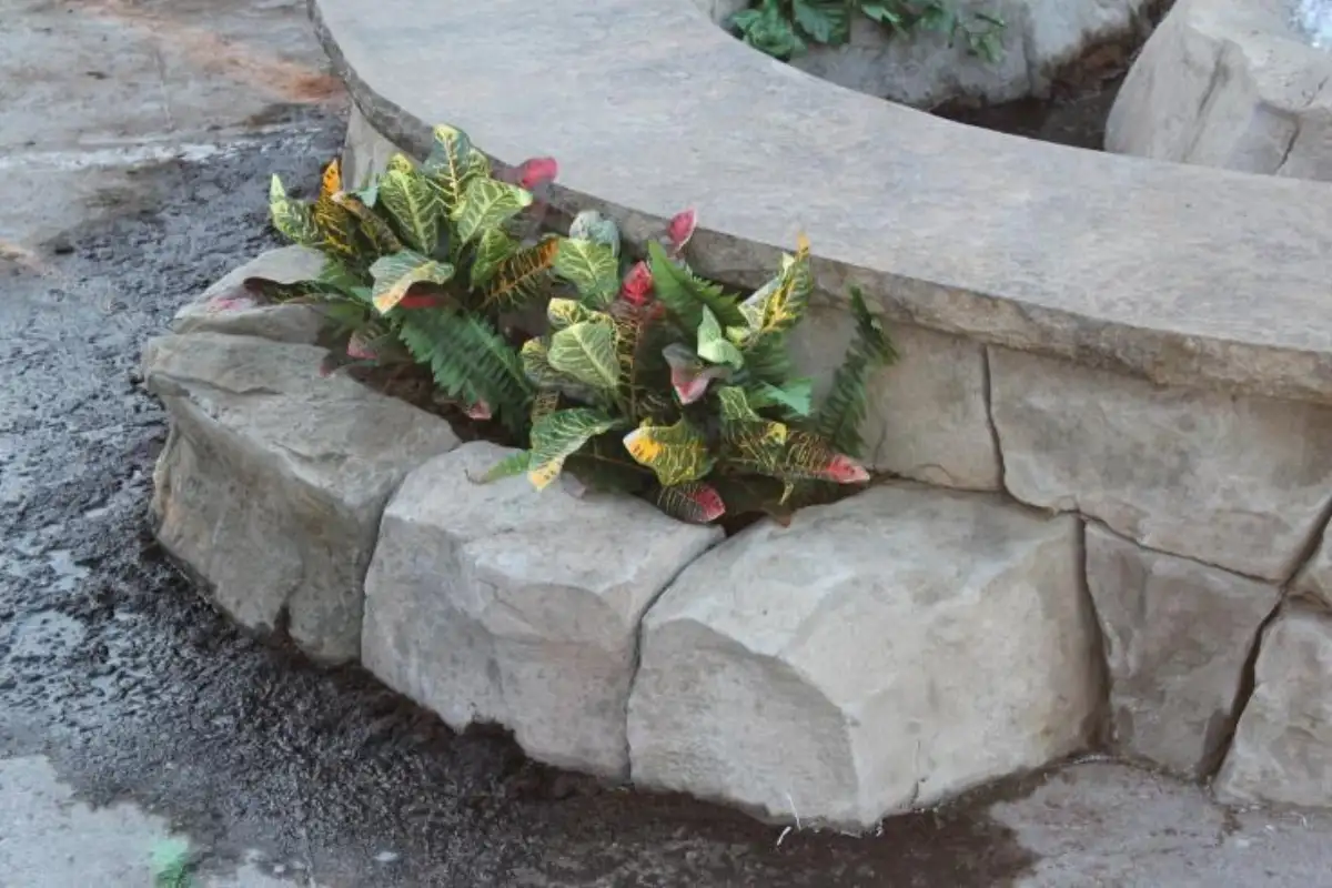 Sculpted concrete retaining element and steps
