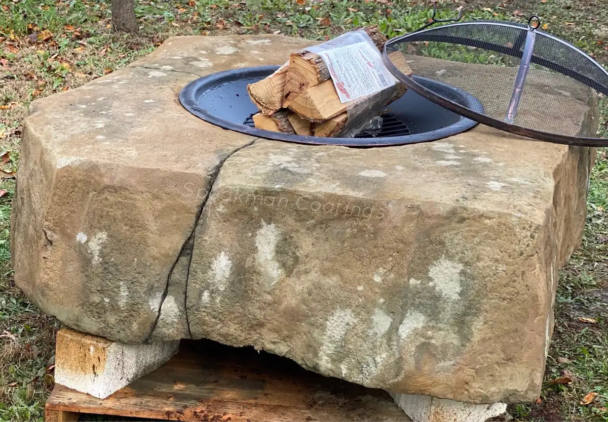 Sculpted fire rock installation showing natural rock texture with integrated gas flames