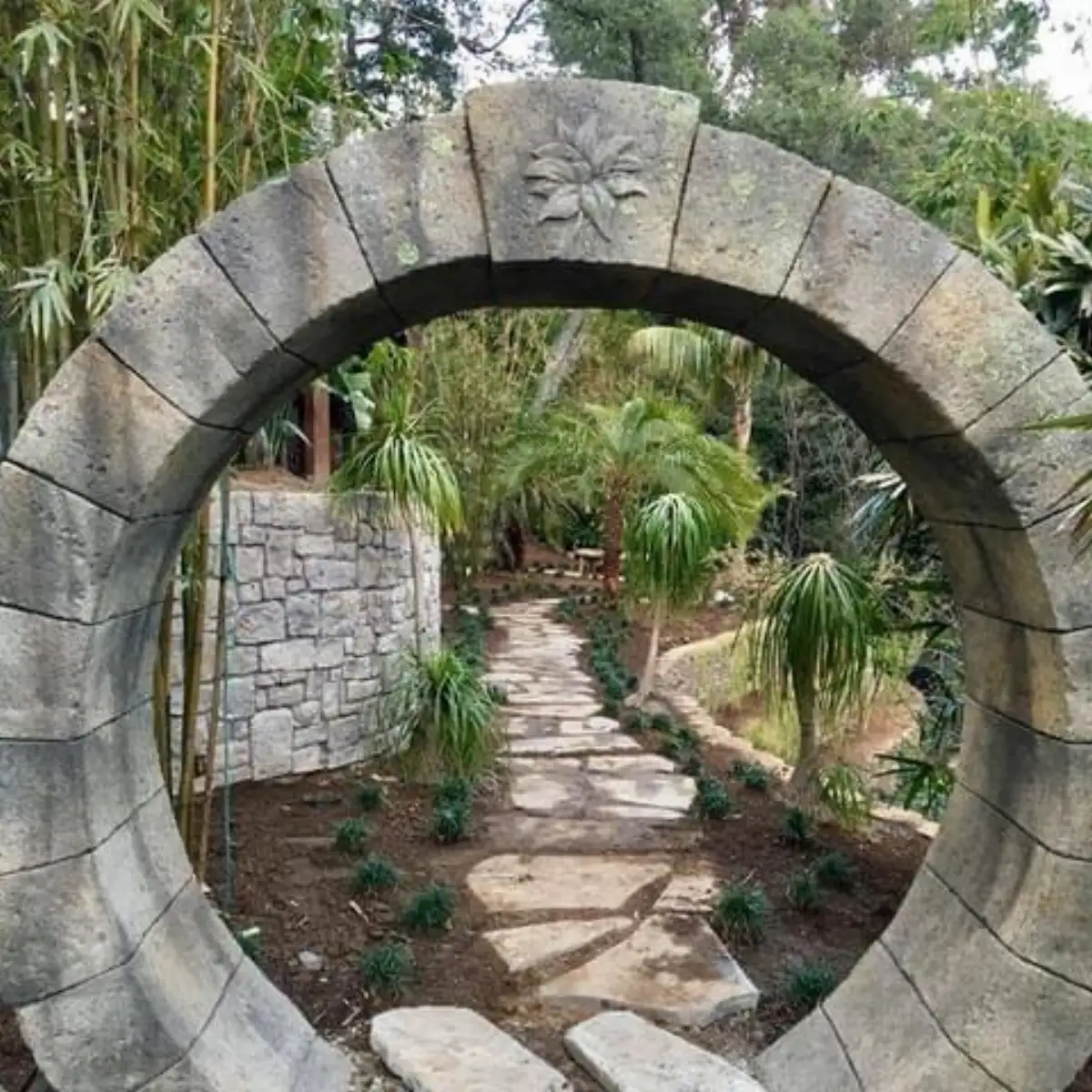 Hand-sculpted moongate garden archway with stone texture