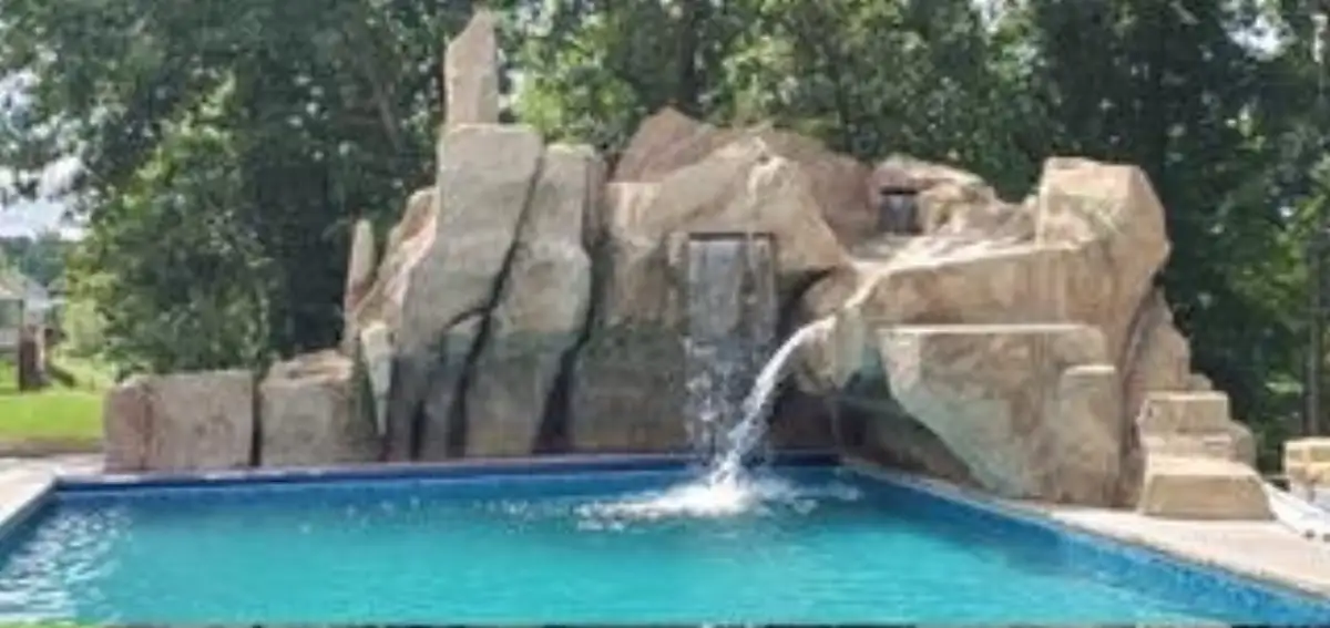Custom sculpted pool slide with smooth polished surface