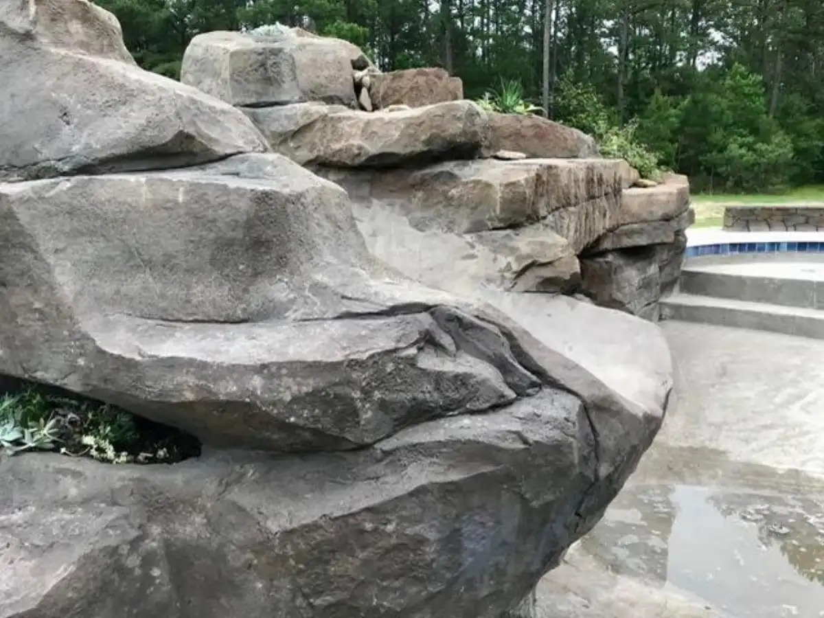 Polished concrete slide splash zone at pool entry